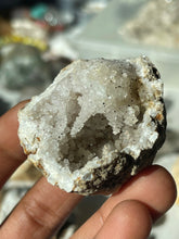 Load image into Gallery viewer, Quartz geode with brown calcite spexks